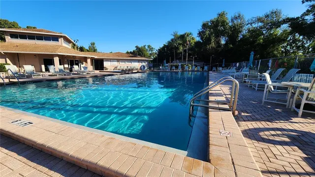 swimming pool view with a seating space