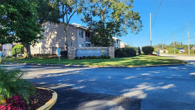 a view of a backyard with plants and tree s