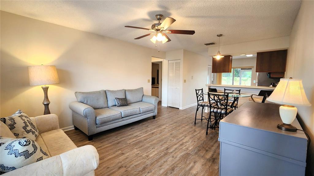 6440 Spring Flower Drive, Unit 14 New Port Richey, FL 34653 - Photo 5 of 35 a living room with furniture and a wooden floor