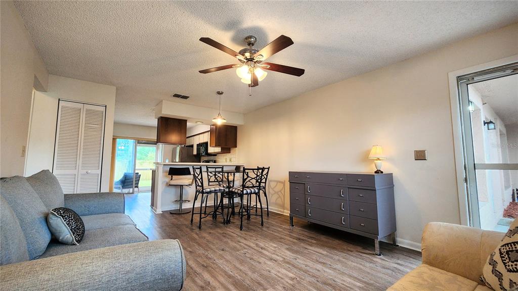 6440 Spring Flower Drive, Unit 14 New Port Richey, FL 34653 - Photo 6 of 35 a living room with furniture and view of kitchen