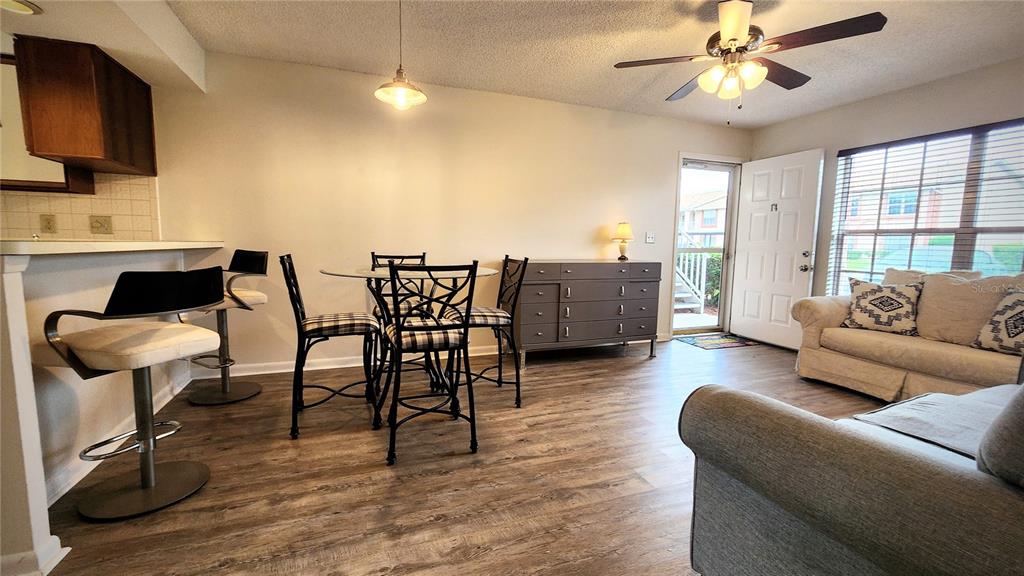 6440 Spring Flower Drive, Unit 14 New Port Richey, FL 34653 - Photo 7 of 35 a living room with furniture a flat screen tv and a large window