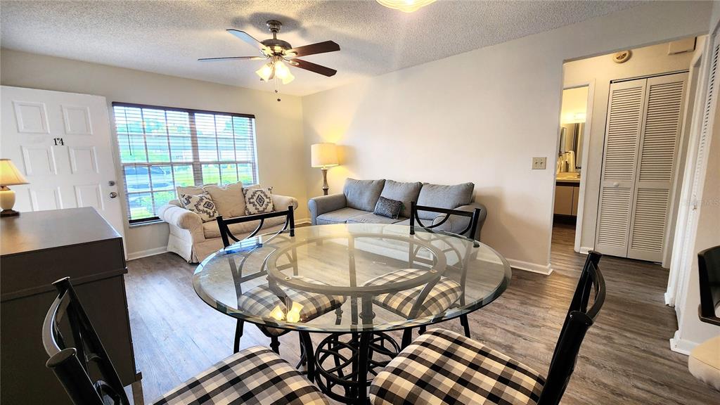 6440 Spring Flower Drive, Unit 14 New Port Richey, FL 34653 - Photo 8 of 35 a living room with furniture and a chandelier