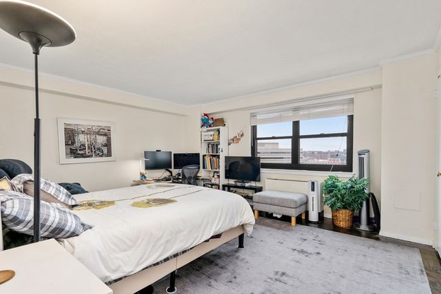 a bedroom with bed a table and chair