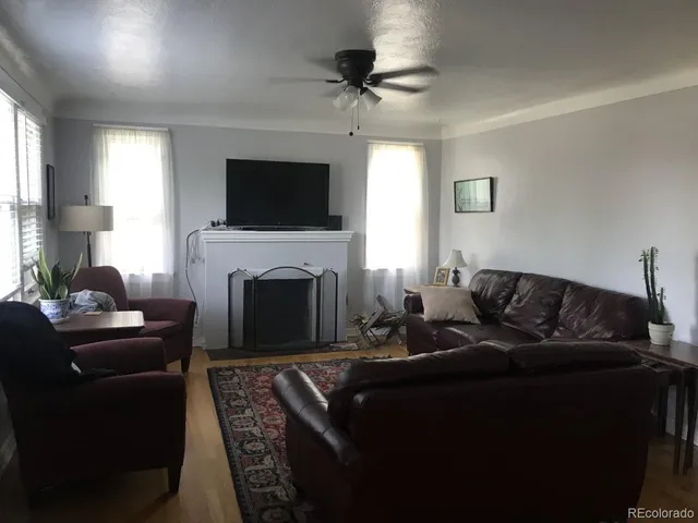 a view of empty room with wooden floor and fireplace