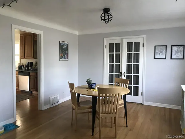 a view of a dining room with furniture and window