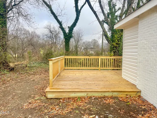 a view of balcony with wooden floor and fence