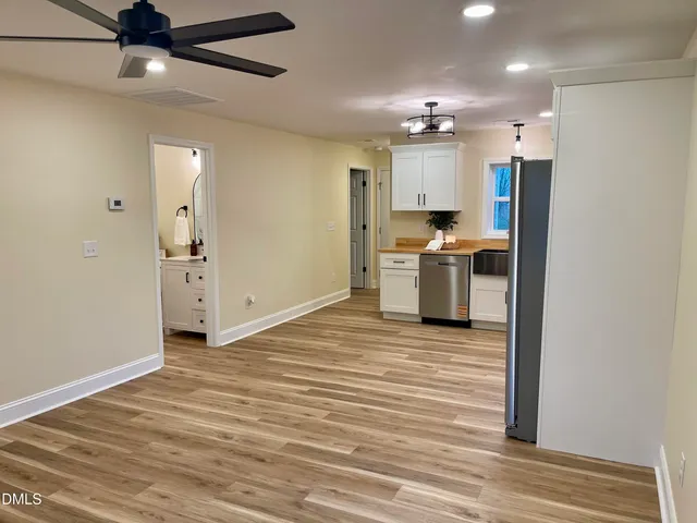 a view of a kitchen with a sink and a refrigerator