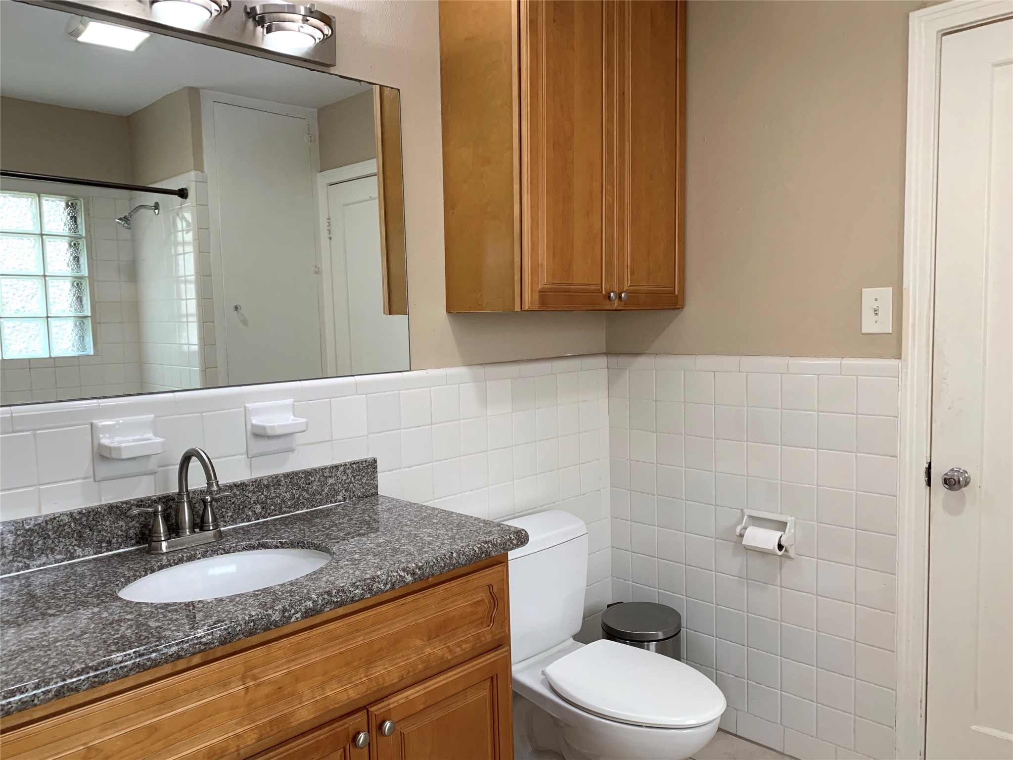 307 Avondale Street, Unit 1 Houston, TX 77006 - Photo 12 of 22 Granite counter top in updated bathroom. Also extra storage cabinet over toilet.