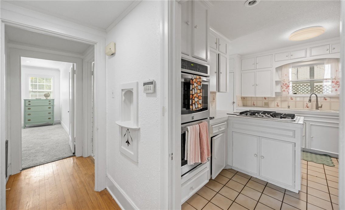 245 Leming Avenue Corpus Christi, TX 78404 - Photo 11 of 33 a kitchen with white cabinets and white appliances