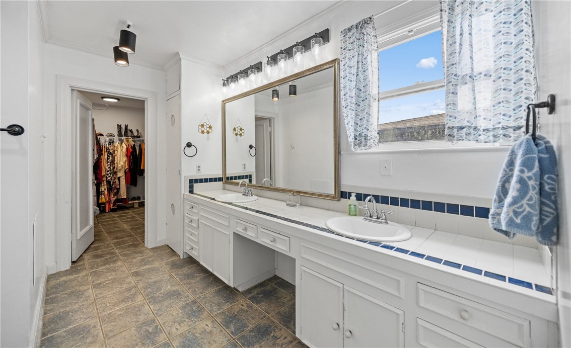 245 Leming Avenue Corpus Christi, TX 78404 - Photo 20 of 33 a bathroom with a granite countertop sink and a mirror
