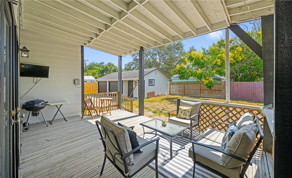 245 Leming Avenue Corpus Christi, TX 78404 - Photo 26 of 33 a view of a patio with table and chairs potted plants with wooden floor and fence
