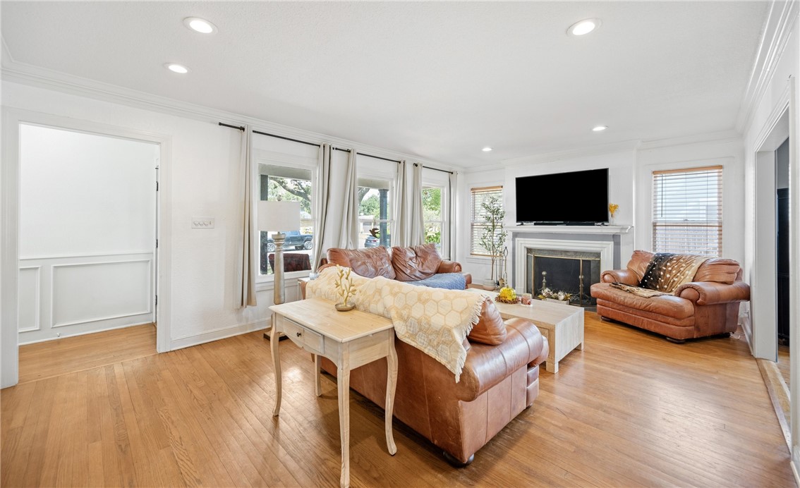 245 Leming Avenue Corpus Christi, TX 78404 - Photo 3 of 33 a living room with furniture a fireplace a flat screen tv and a large window