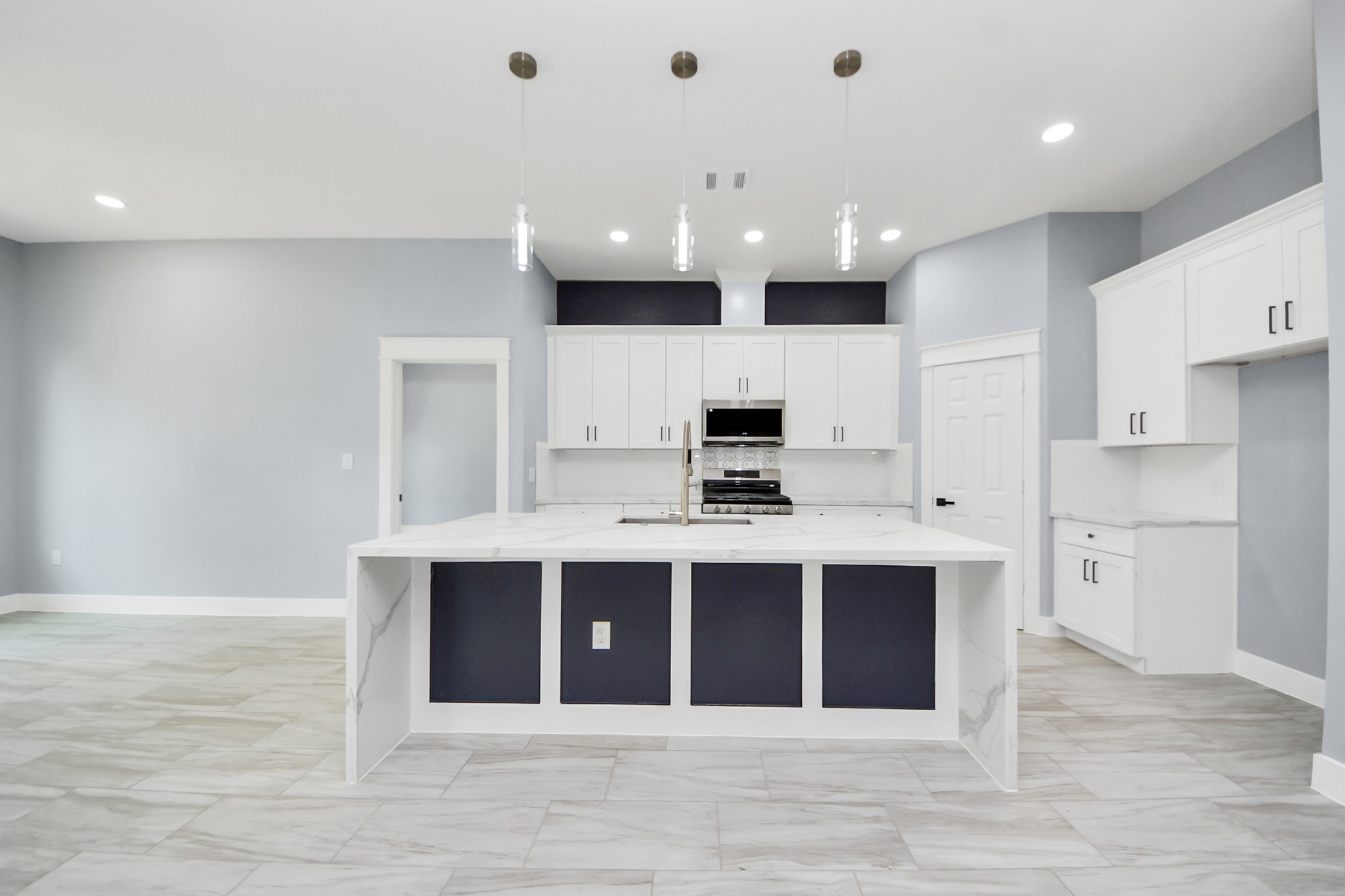 406 South Iowa Street La Porte, TX 77571 - Photo 15 of 49 a large kitchen with kitchen island a sink dishwasher a stove and a refrigerator with wooden floor