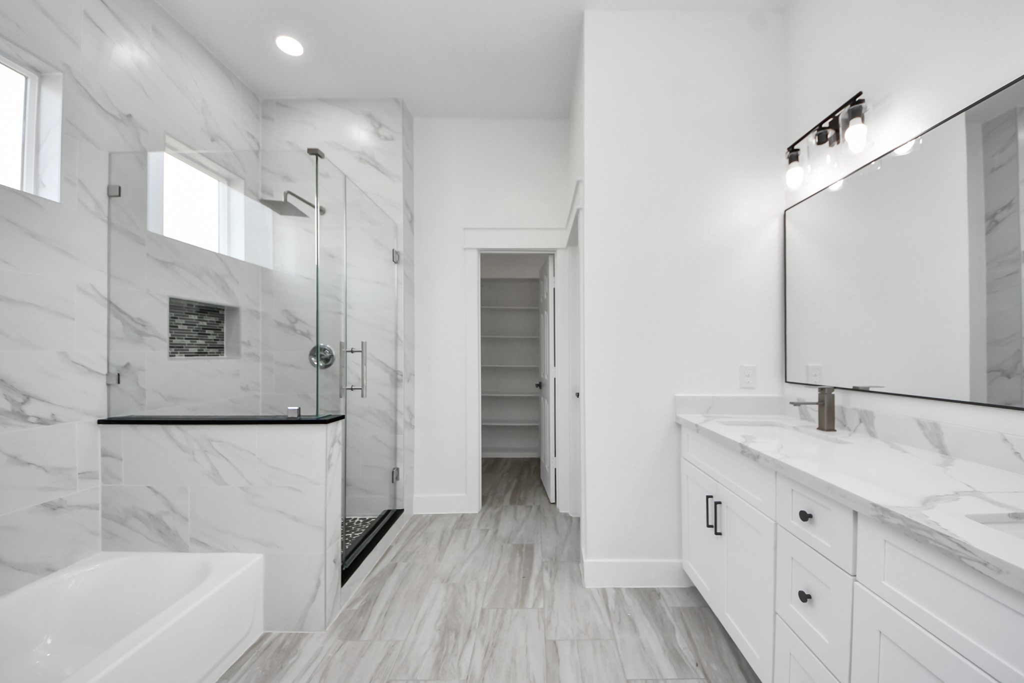 406 South Iowa Street La Porte, TX 77571 - Photo 26 of 49 a bathroom with a double vanity sink a mirror and a bathtub
