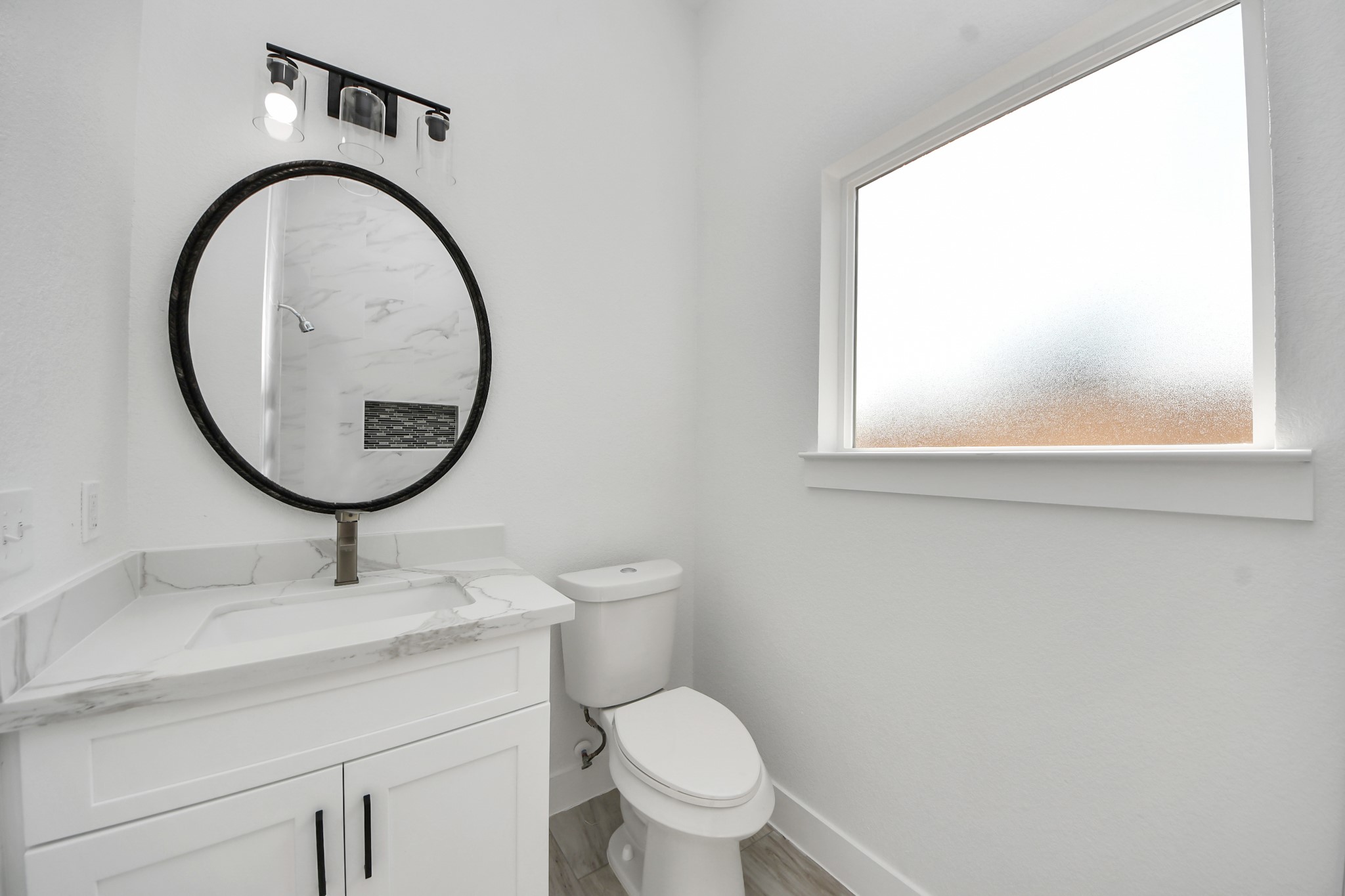406 South Iowa Street La Porte, TX 77571 - Photo 37 of 49 a bathroom with a toilet a sink and a mirror