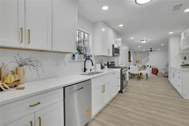 a kitchen with counter top space cabinets and appliances