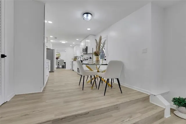 a view of a dining room with furniture and wooden floor