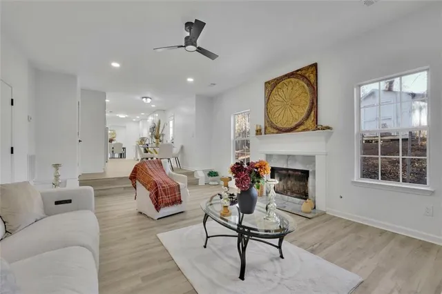 a living room with furniture a fireplace and window