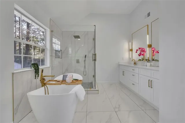 a bathroom with a sink mirror and a bathtub