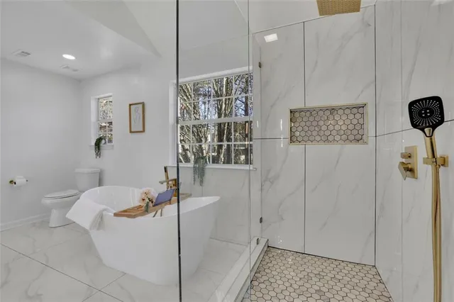 a bathroom with a bathtub and shower