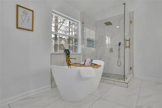 a bath room with a bath tub and shower