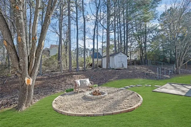 a view of a fire pit in a backyard