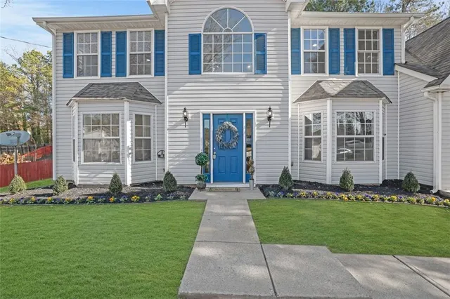 a front view of a house with a yard
