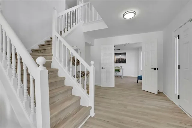 a view of entryway and hall with wooden floor