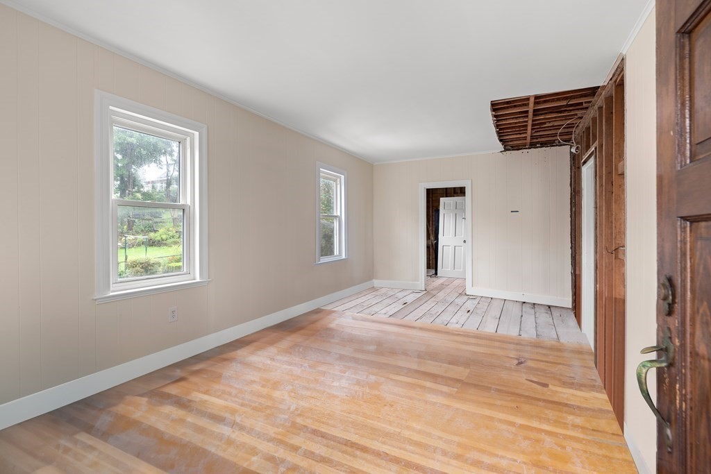 69 Fox Hill Road Nahant, MA 01908 - Photo 14 of 42 a view of an empty room with wooden floor and a window
