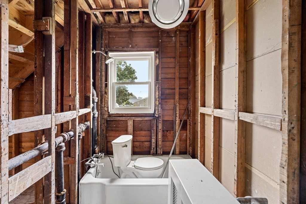 69 Fox Hill Road Nahant, MA 01908 - Photo 20 of 42 a bathroom with a toilet a sink and a large mirror