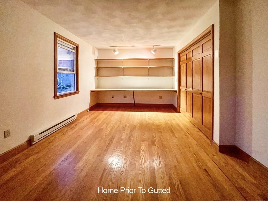 69 Fox Hill Road Nahant, MA 01908 - Photo 31 of 42 a view of an empty room with wooden floor and a window