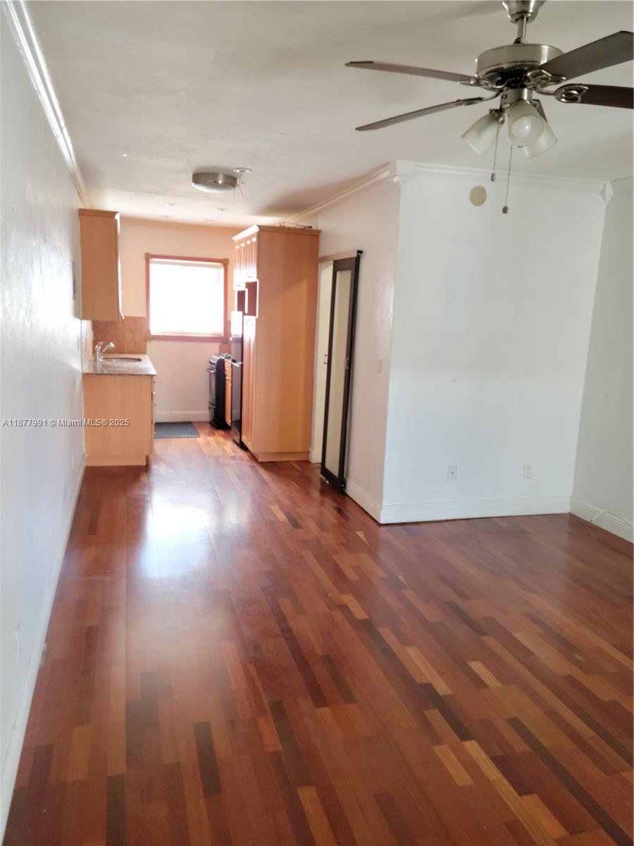 7315 Byron Avenue, Unit 17 Miami Beach, FL 33141 - Photo 2 of 10 wooden floor in an empty room with a window