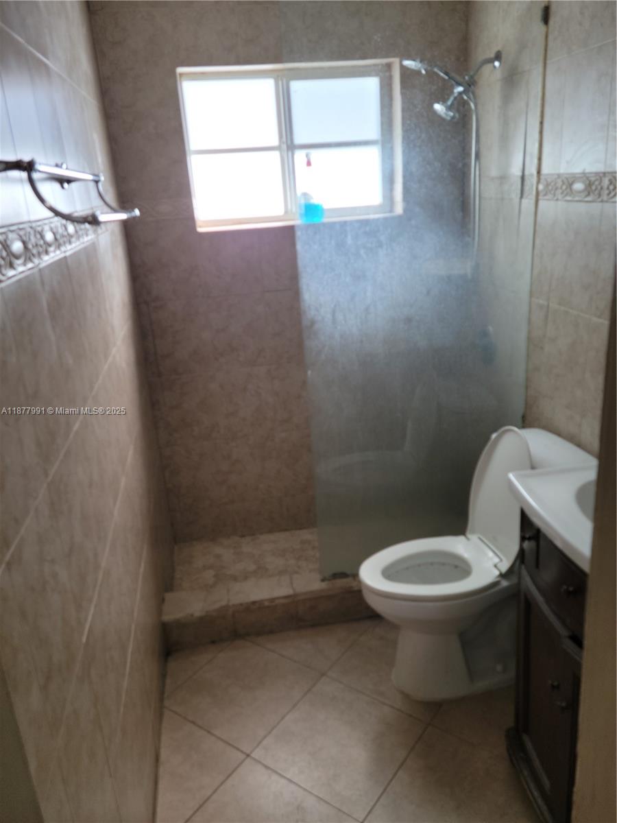 7315 Byron Avenue, Unit 17 Miami Beach, FL 33141 - Photo 7 of 10 a bathroom with a toilet and a shower