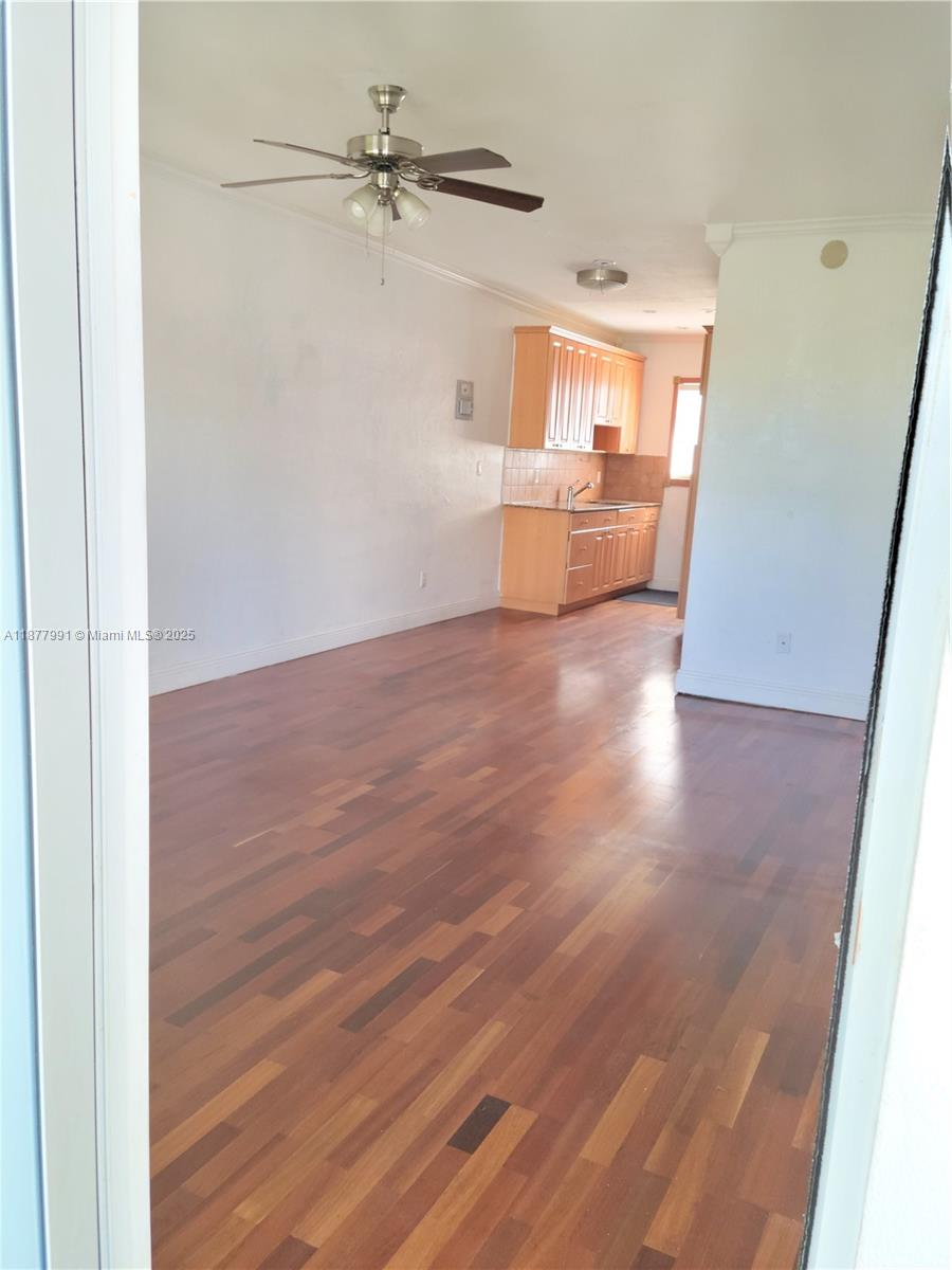 7315 Byron Avenue, Unit 17 Miami Beach, FL 33141 - Photo 9 of 10 wooden floor in an empty room with a window