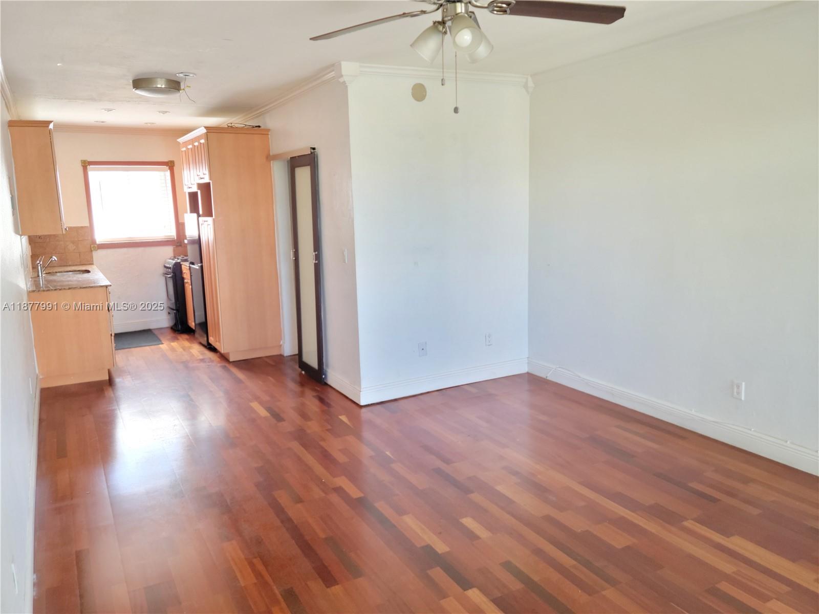 7315 Byron Avenue, Unit 17 Miami Beach, FL 33141 - Photo 10 of 10 an empty room with wooden floor and a window