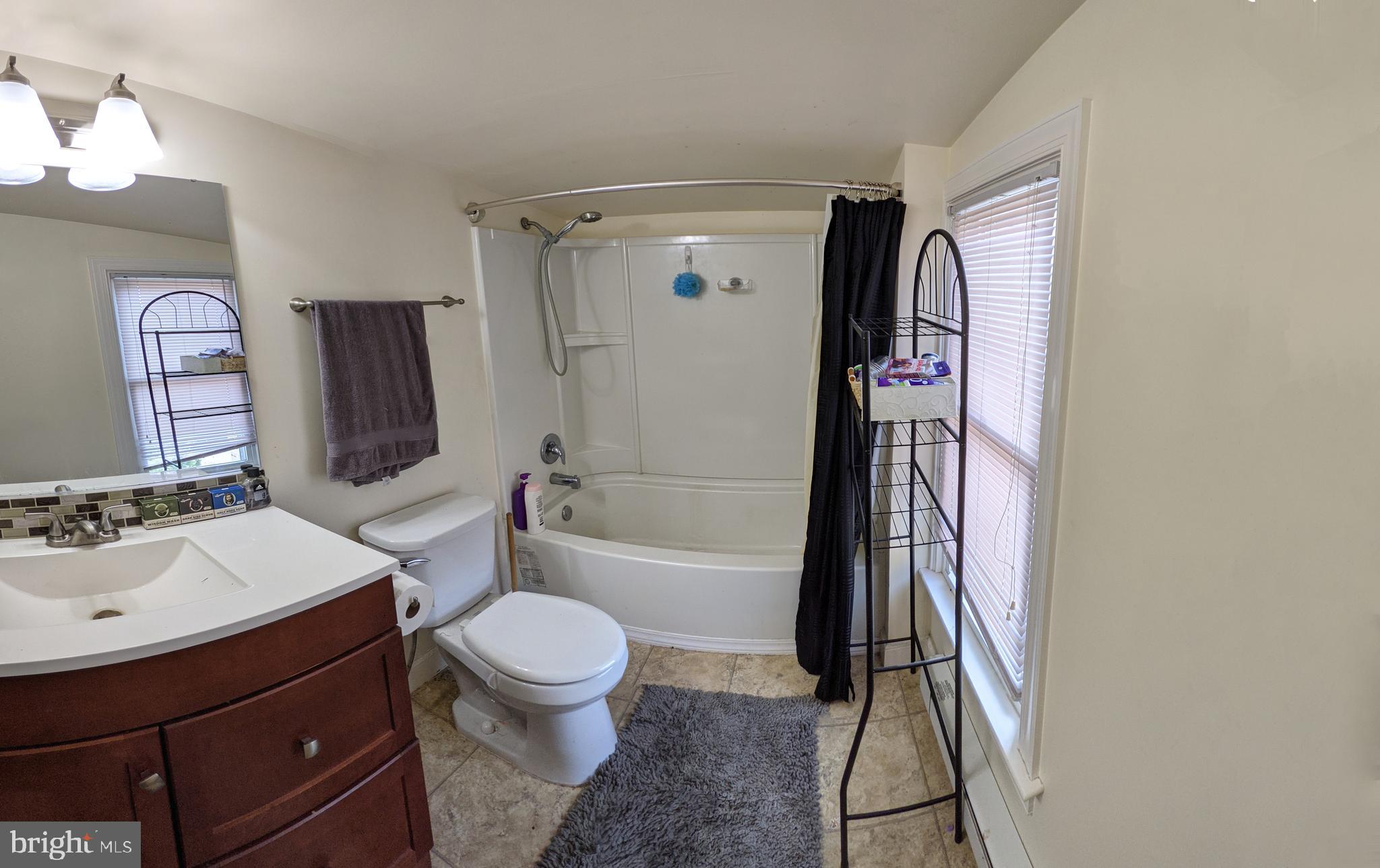 442 South Main Street, Unit A Manheim, PA 17545 - Photo 19 of 26 a bathroom with a sink toilet vanity and shower