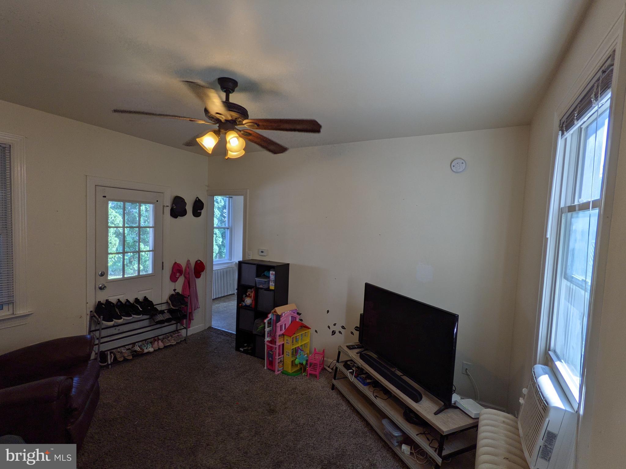 442 South Main Street, Unit A Manheim, PA 17545 - Photo 9 of 26 a living room with furniture a flat screen tv and a window
