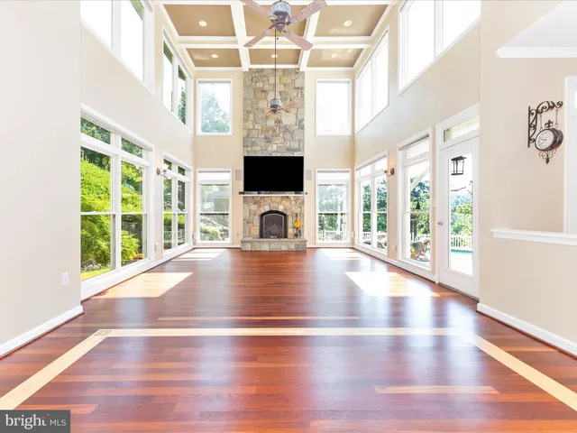 a kitchen with stainless steel appliances granite countertop a sink and cabinets with wooden floor