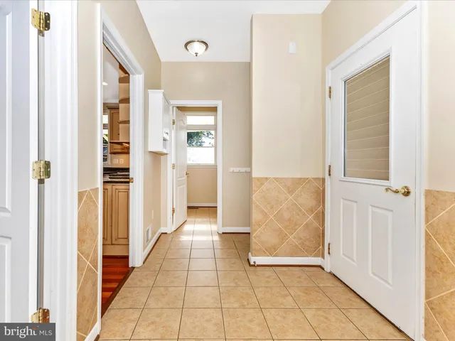 a spacious bathroom with a tub and a large window