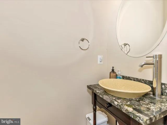 an empty room with windows and ceiling fan