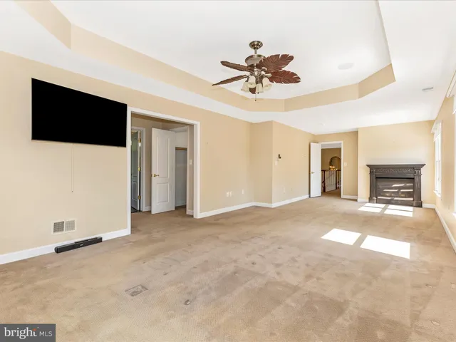 a view of a house with backyard water fountain and sitting area