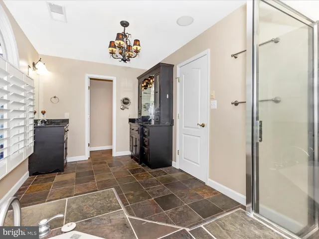 a view of a swimming pool with lawn chairs under an umbrella