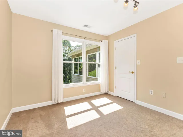 a backyard of a house with a yard and outdoor seating