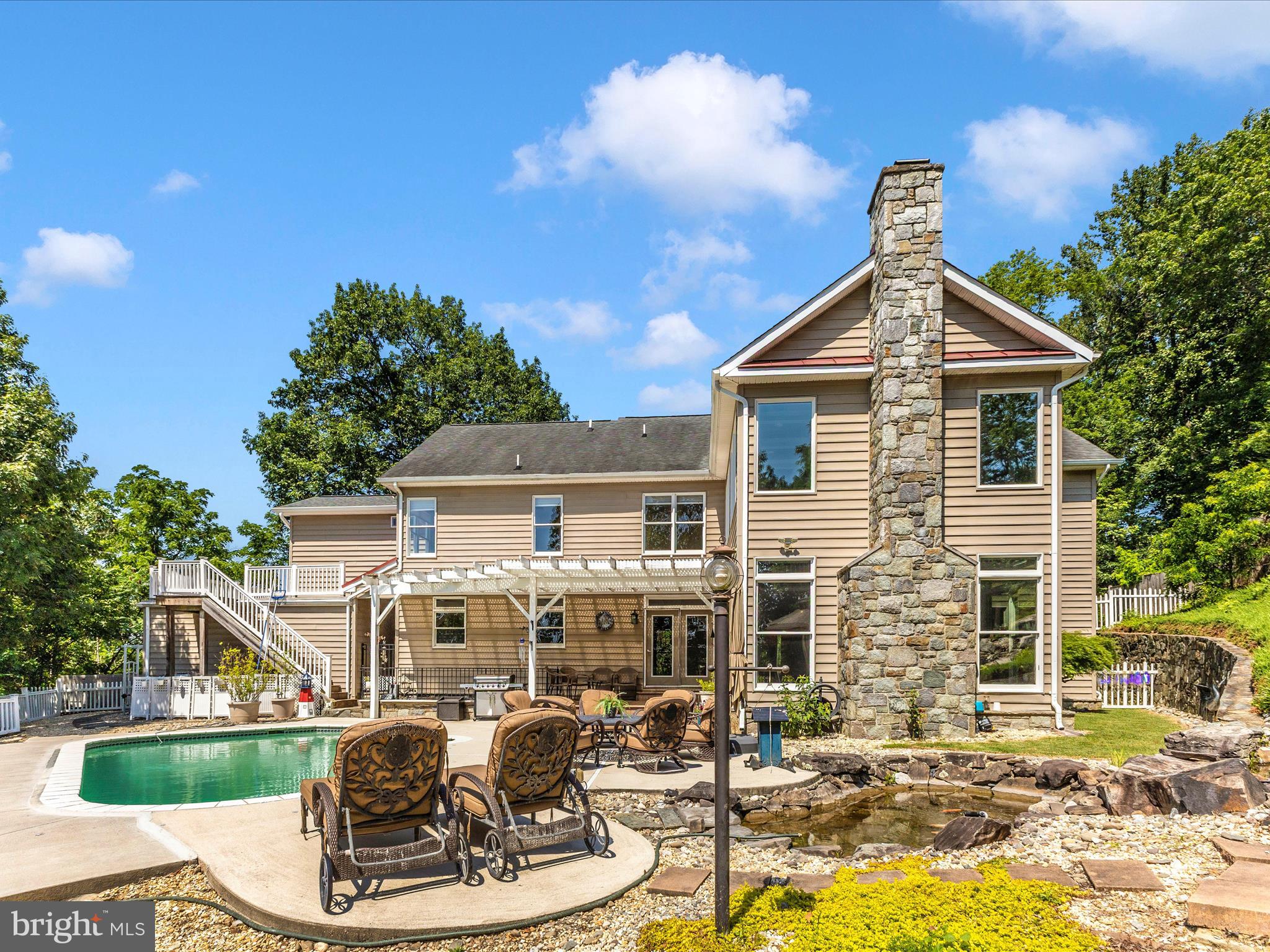 2305 Mt Ephraim Road Adamstown, MD 21710 - Photo 51 of 87 a view of a house with backyard water fountain and sitting area