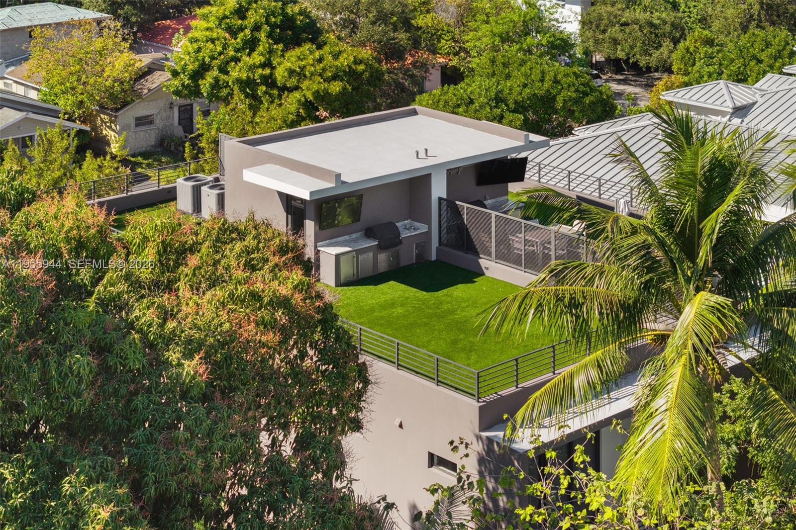 3151 Hibiscus Street, Unit 3151 Miami, FL 33133 - Photo 37 of 47 an aerial view of a house with swimming pool and large trees