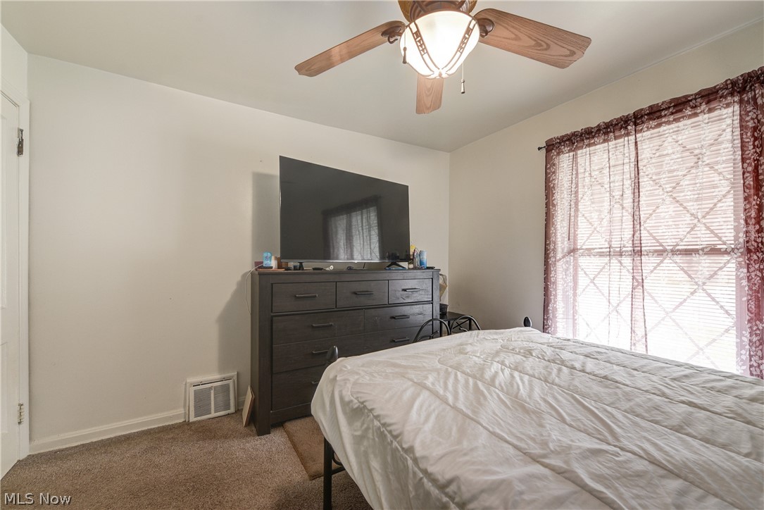 3735 Highland Road Cleveland, OH 44111 - Photo 25 of 35 Bedroom featuring carpet, ceiling fan, and multiple windows
