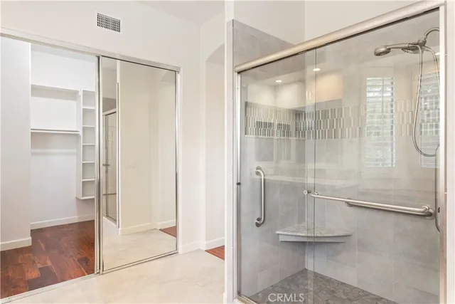a bathroom with a glass shower door