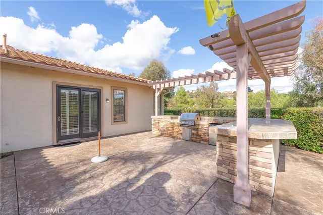 a view of a house with swimming pool and a chairs
