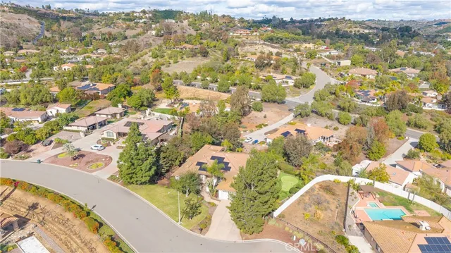 an aerial view of a house with a swimming pool