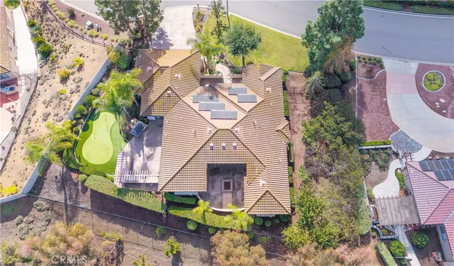 an aerial view of a house with a yard and garden